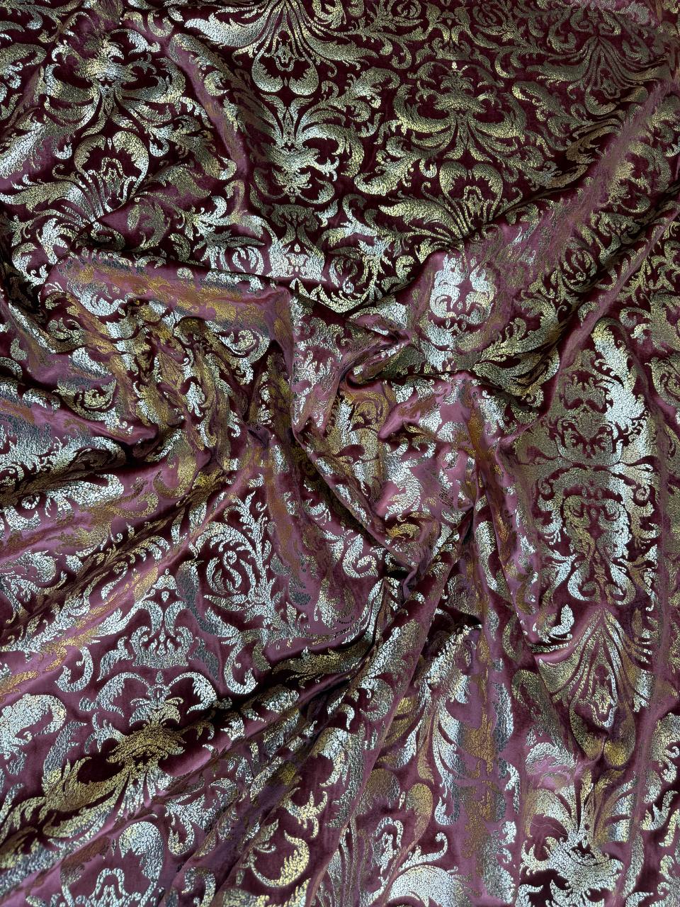 Burgundy Damask fabric: damask-inspired ornament in burgundy and pale metallic tones. Original fabric photograph.