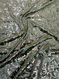 Sage Scroll fabric: scrolling botanical vines in sage and pale metallic tones. Original fabric photograph.