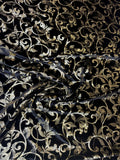 Black & Gold Scroll fabric: ornamental scrollwork in black and gold tones. Original fabric photograph.