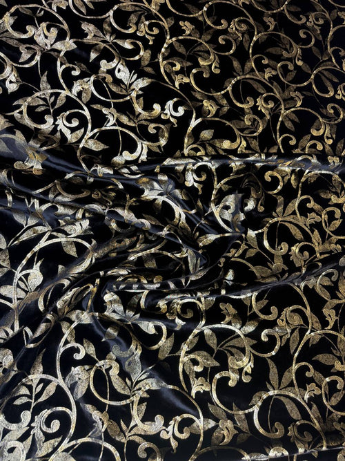 Black & Gold Scroll fabric: ornamental scrollwork in black and gold tones. Original fabric photograph.