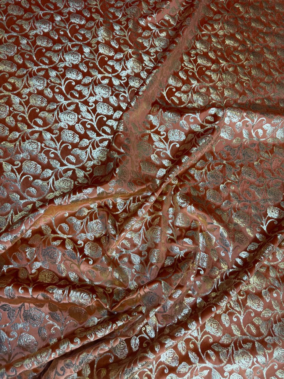 Terracotta Leaf fabric: small botanical repeat in terracotta and pale metallic tones. Original fabric photograph.