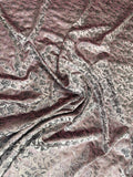 Rose Damask fabric: damask-inspired ornament in rose and metallic tones. Original fabric photograph.