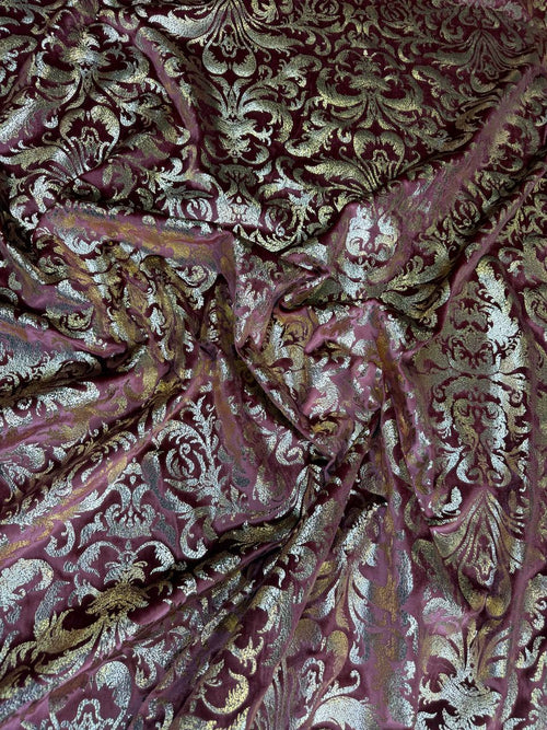 Burgundy Damask fabric: damask-inspired ornament in burgundy and pale metallic tones. Original fabric photograph.