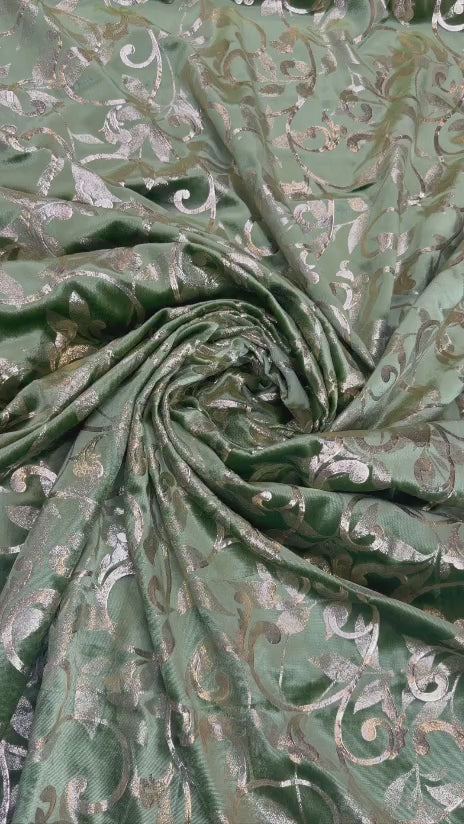Original video showing sage scroll fabric in movement, with scrolling botanical vines.