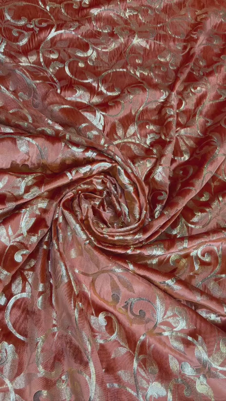 Original video showing terracotta scroll fabric in movement, with ornamental scrollwork.