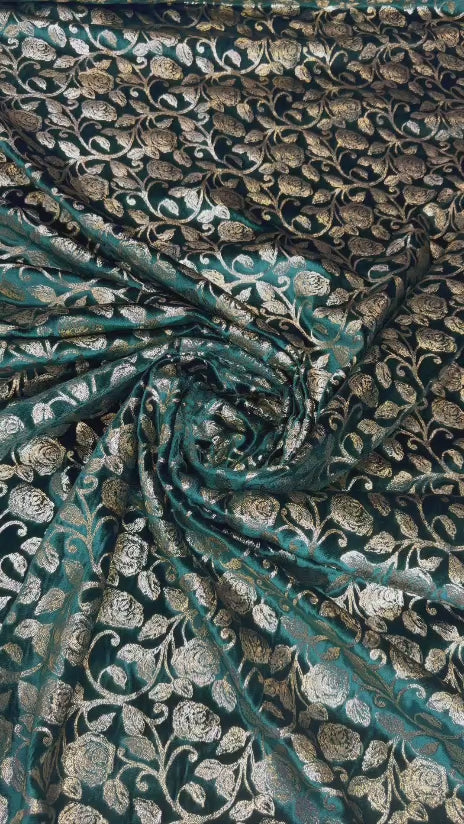 Original video showing teal leaf fabric in movement, with dense botanical repeat.